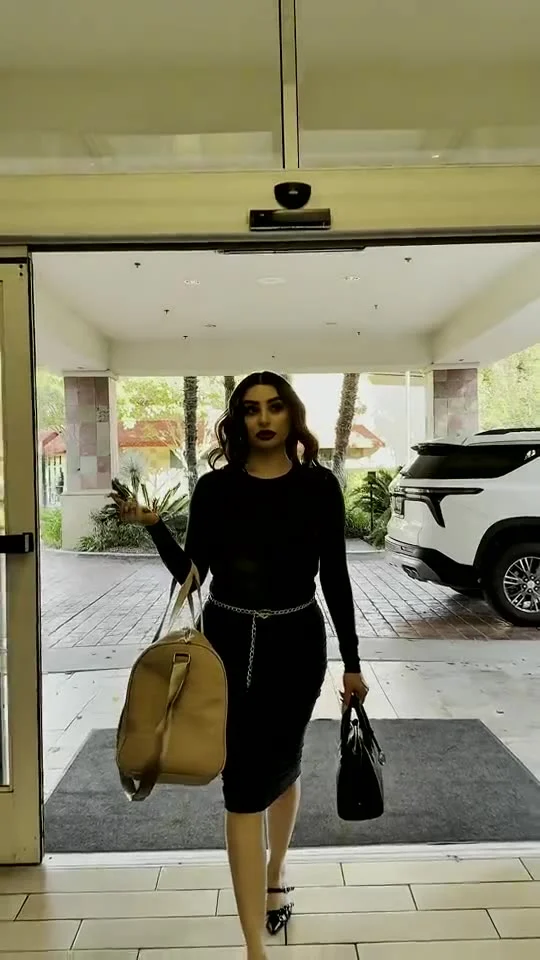 Maria Marron arriving at Hilton Garden Inn with luggage